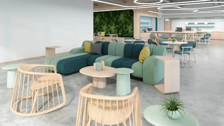 Open collaboration space with a Martin Brattrud Monterey modular sofa, Bernhardt Harper lounge chairs, an Andreu World Arc coffee table, Hightower Proto oval side tables and, in the café beyond, Grand Rapids Ferdinand chairs with HBF Studio standing tables; the preserved moss wall, curved ceiling detail, ribbon lighting and polished concrete floor all modeled to match the project as designed