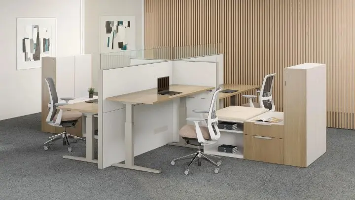 Workstation cluster using the Teknion District system with height-adjustable surfaces, glass topper screens and tower storage, paired with Haworth Soji task chairs and shown in a pre-designed setting with a wood slat wall