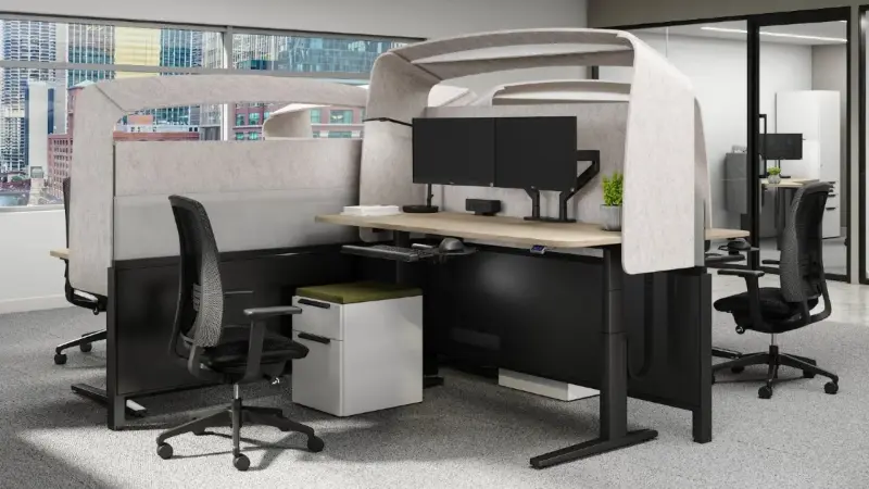 Height-adjustable meeting table enclosed by a Teknion Hoodie screen with Teknion Around chairs, Anomatics